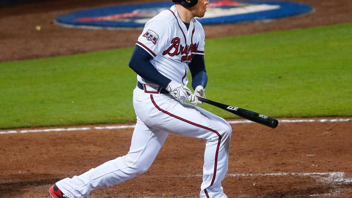Atlanta Braves first baseman Freddie Freeman (5) follows through on a base hit in the eighth inning of a baseball game against the Miami Marlins on Friday.