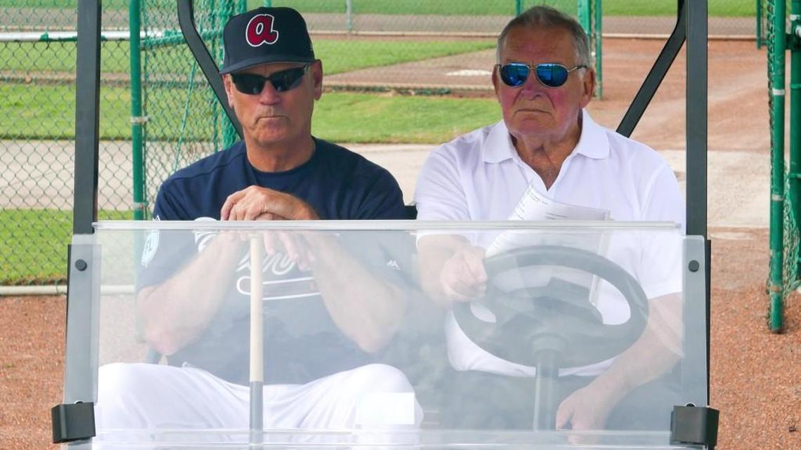 Atlanta Braves manager Brian Snitker, left, and former manager Bobby Cox watch players practice at spring training this past week.