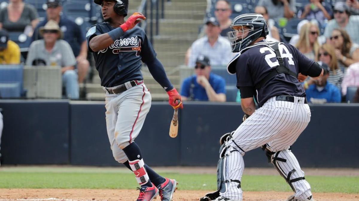 Atlanta Braves' Ozzie Albies watches with New York Yankees catcher Gary Sanchez after hitting a single during their March 2 game in Tampa, Fla.