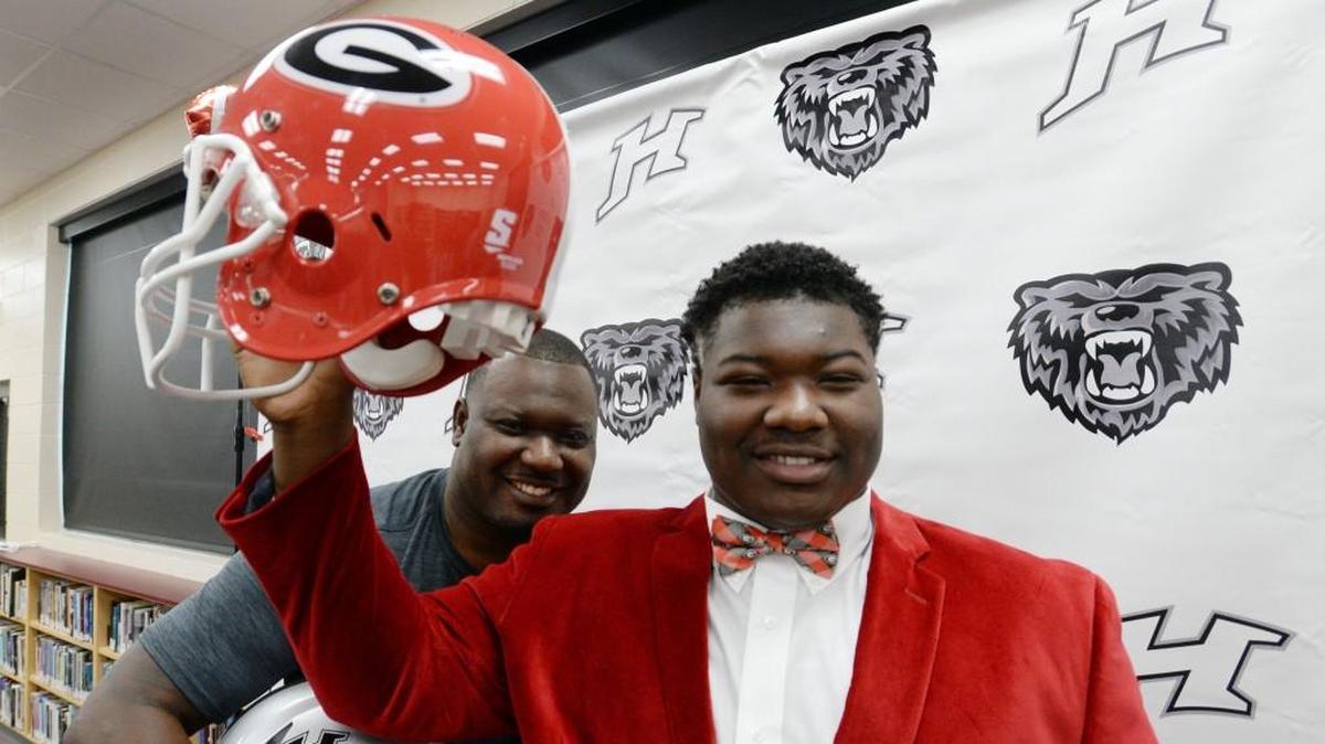 Trey Hill holds his new hat after signing a commitment to attend Georgia starting this winter. Hill's brother, Derrick, played football at Valdosta State where he was coached by Kirby Smart.