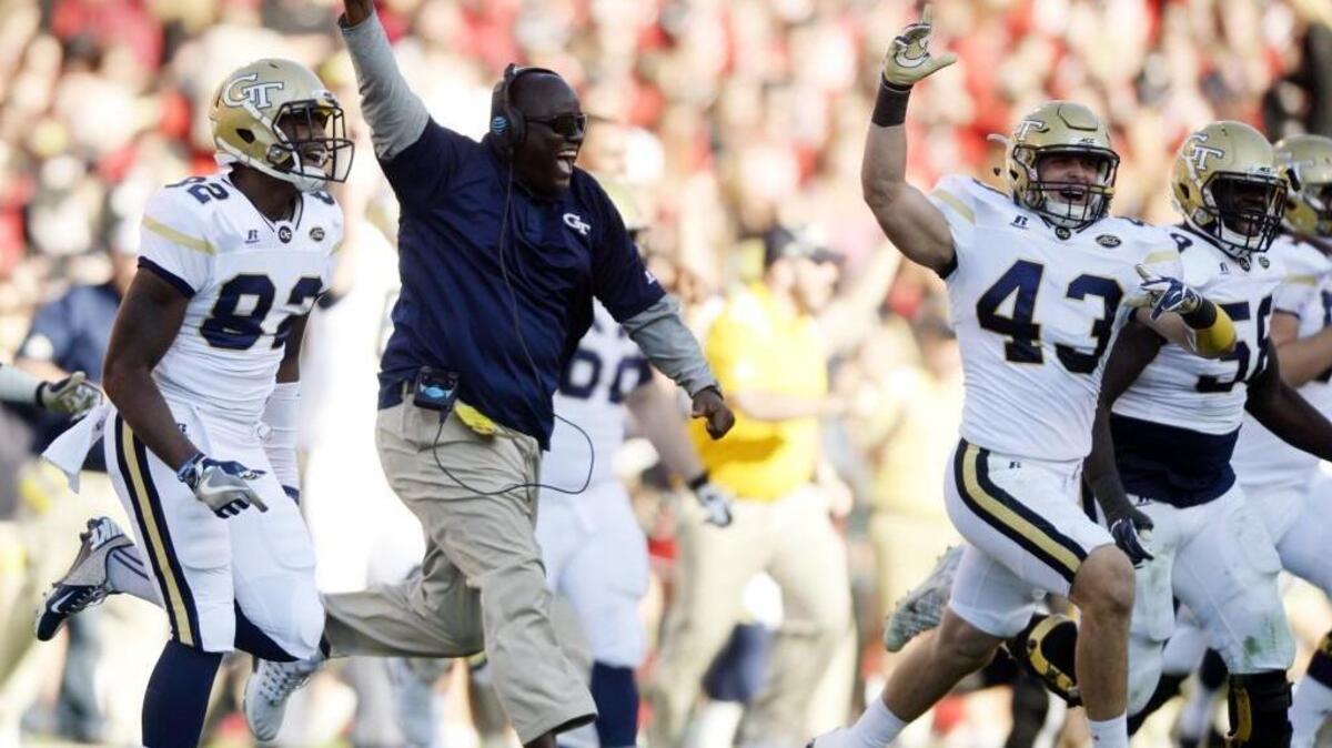 Georgia Tech players and coaches celebrate their 28-27 win over Georgia on Saturday in Athens.