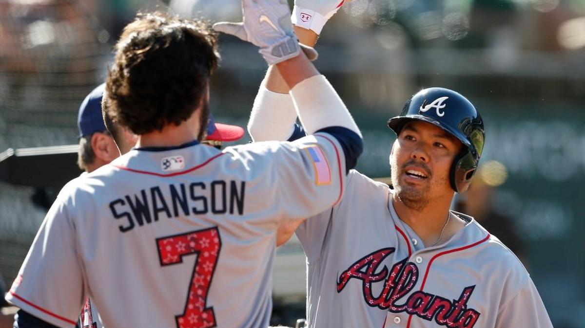 Atlanta’s Kurt Suzuki, right, celebrates his game-winning home run with teammate Dansby Swanson during Sunday’s game in Oakland.