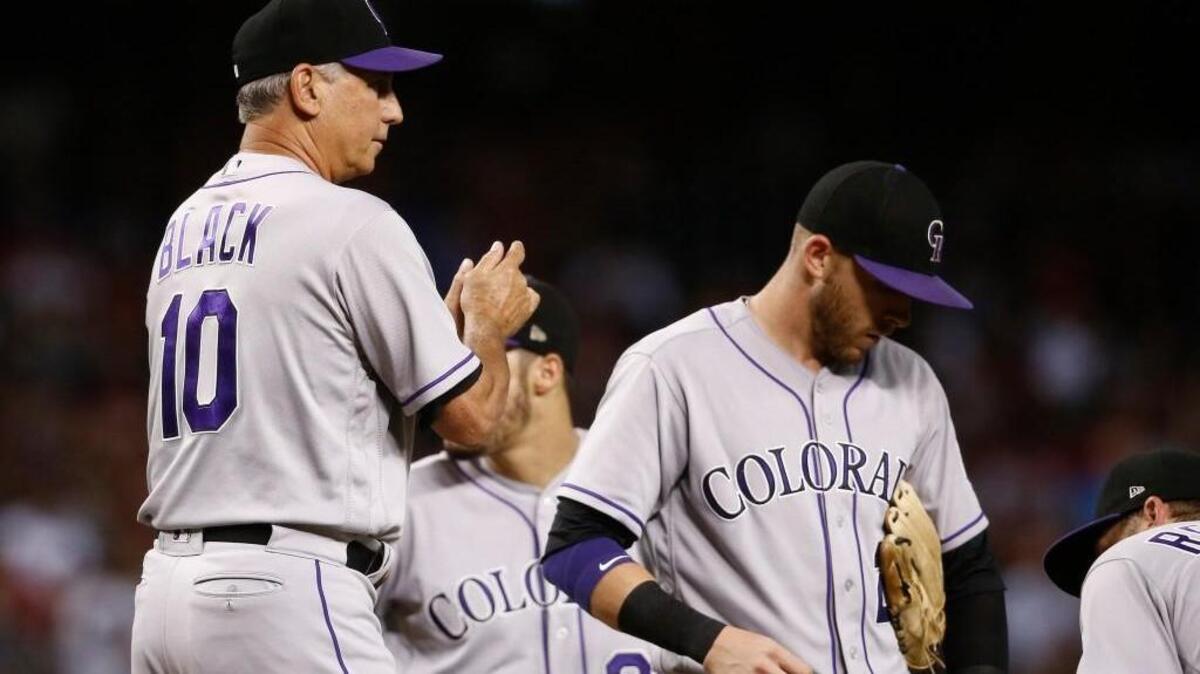 Colorado manager Bud Black (10) rubs put the baseball as he waits for a new pitcher with Trevor Story, right, during the ninth inning of a baseball game against the Arizona Diamondbacks Tuesday, Sept. 12, 2017, in Phoenix. The Rockies defeated the Diamondbacks 4-2.