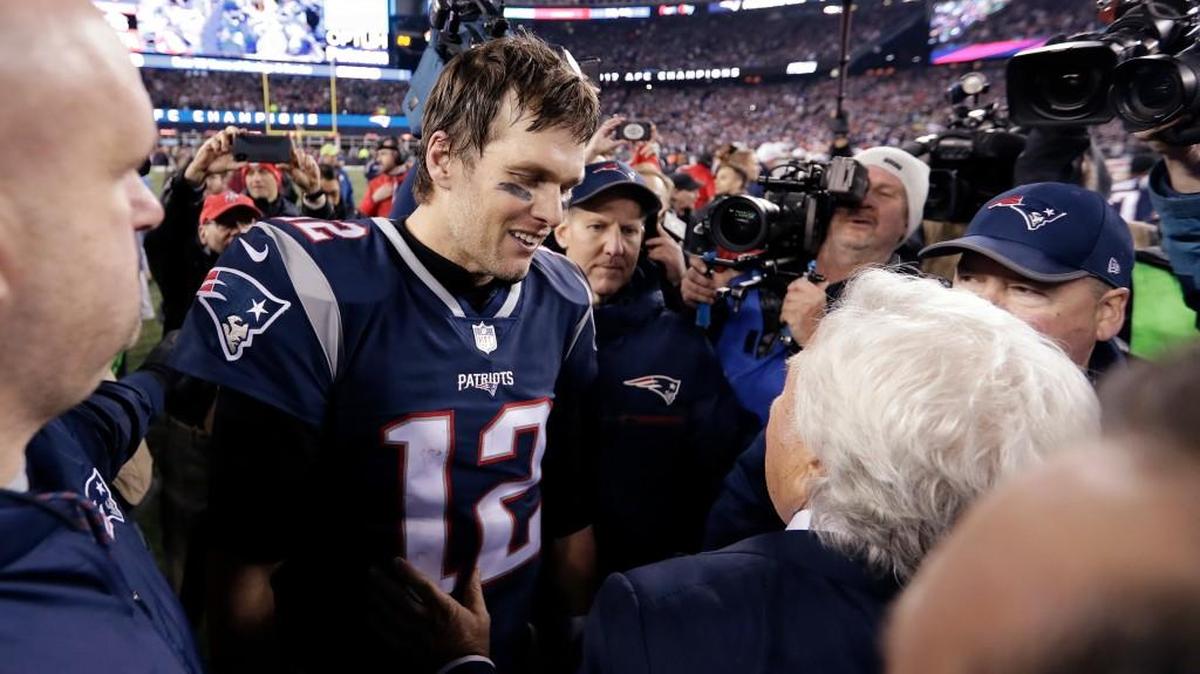 New England Patriots quarterback Tom Brady (12) and owner Robert Kraft speak at midfield after winning the AFC championship NFL football game against the Jacksonville Jaguars.