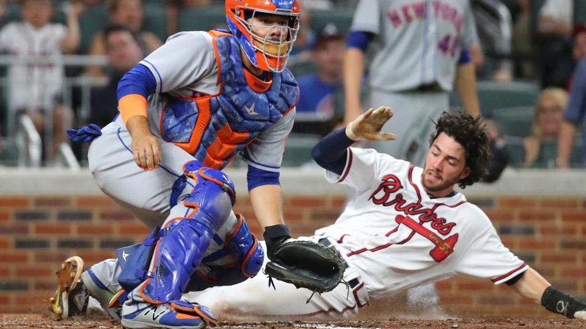 Atlanta’s Dansby Swanson scores past New York Mets catcher Rene Rivera on a two-run triple by Emilio Bonifacio during the fourth inning of a MLB baseball game on Wednesday, May 3, 2017, in Atlanta.