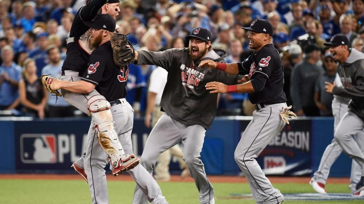 In this Wednesday, Oct. 19, 2016, file photo, Cleveland Indians relief pitcher Cody Allen (37), cather Roberto Perez (55) and teammates Andrew Miller and Coco Crisp celebrate the team's 3-0 victory over the Toronto Blue Jays during Game 5 of the baseball American League Championship Series, in Toronto. Four months after LeBron James and the Cavaliers ended the city’s championship drought at 52 years by winning the NBA title, the Indians are back in the World Series for the first time since 1997.