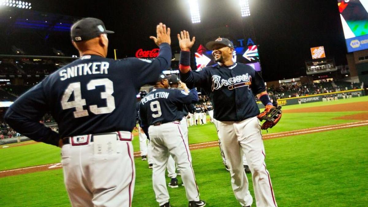 Emilio Bonifacio, right, manager Brian Snitker and the Atlanta Braves open their season Monday at the New York Mets.