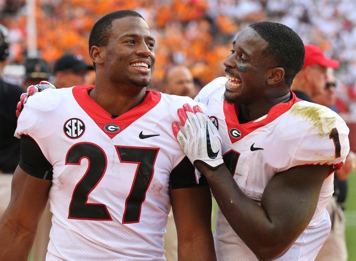 In this Sept. 30, 2017, file photo, Georgia tailbacks Nick Chubb, left, and Sony Michel celebrate on the sidelines during the fourth quarter of a 41-0 shut out over Tennessee in a NCAA college football game, in Knoxville.