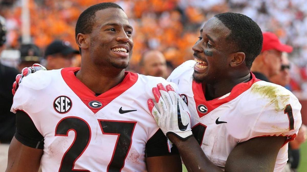 In this Sept. 30, 2017, file photo, Georgia tailbacks Nick Chubb, left, and Sony Michel celebrate on the sidelines during the fourth quarter of a 41-0 shut out over Tennessee in a NCAA college football game, in Knoxville.