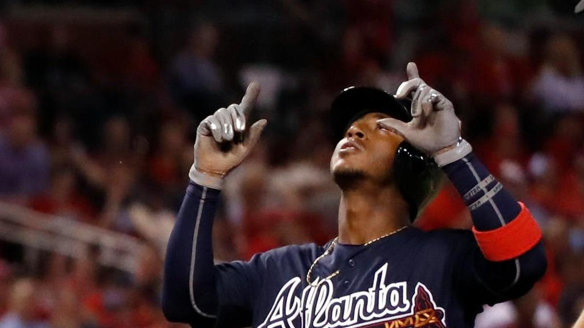 Atlanta’s Ozzie Albies looks skyward as he arrives home after hitting a three-run home run during the sixth inning of the team's baseball game against the St. Louis Cardinals on Friday, Aug. 11, 2017, in St. Louis.