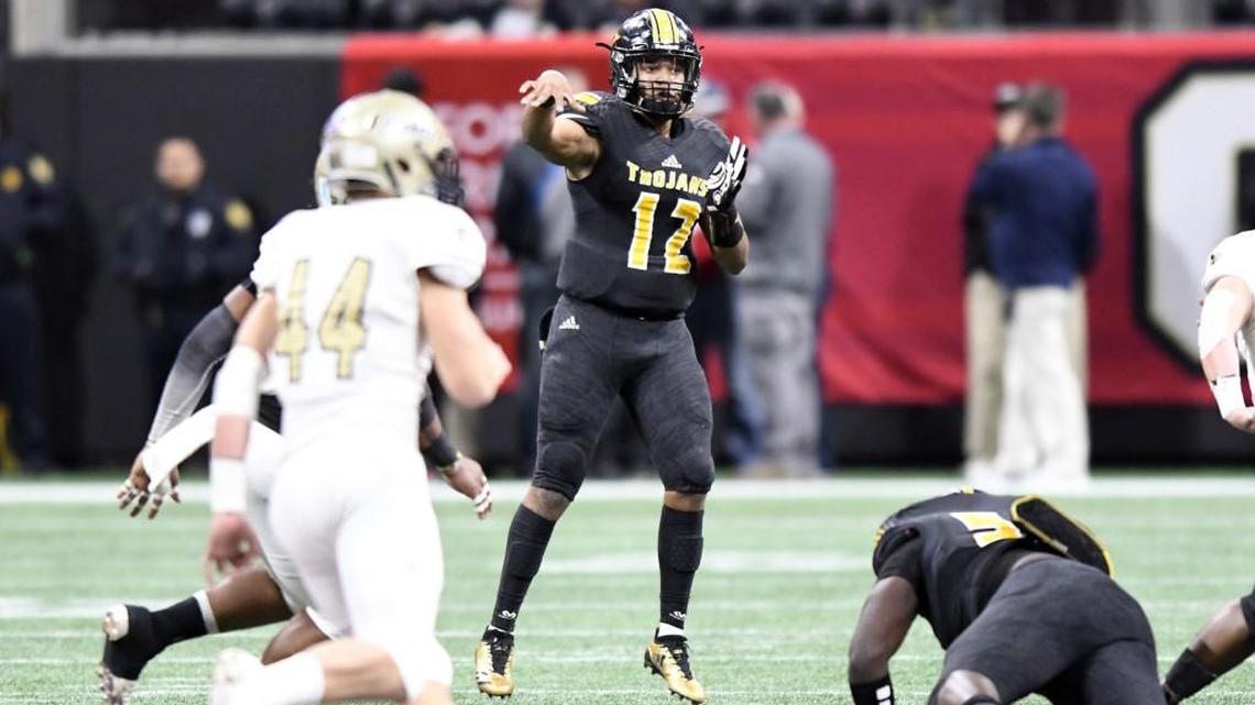 Peach County quarterback Antonio Gilbert (12) throws a pass over the middle during the Trojans' GHSA State Championship loss to Calhoun Friday in Atlanta.