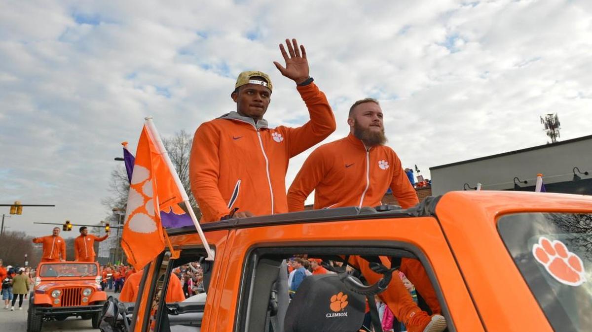 Clemson’s Deshaun Watson, left, and Ben Boulware wave to the crowd during a parade honoring the college football champions Saturday.
