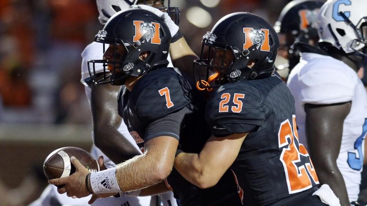Mercer quarterback John Russ gets congrats from Payton Usher (25) after scoring a touchdown Thursday against The Citadel.