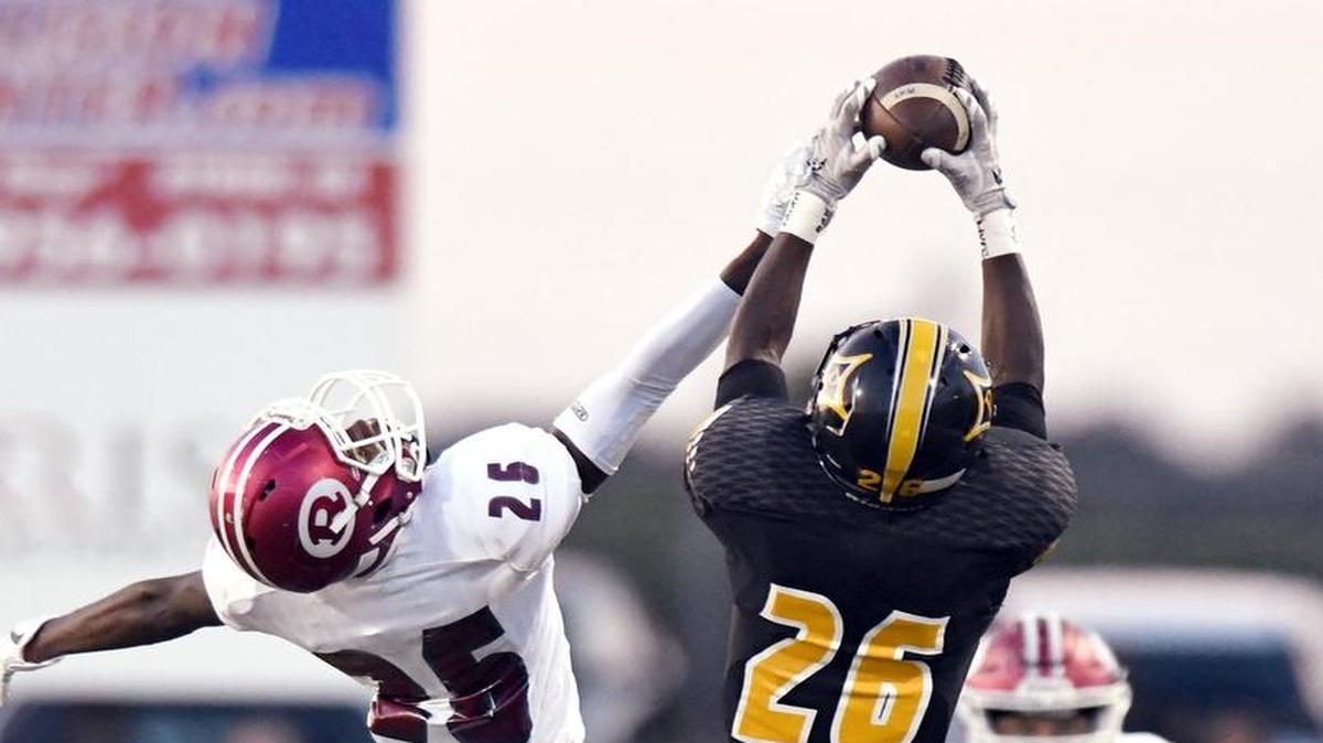 Peach County receiver Millard Thomas, right, hauls in a pass while being covered by Warner Robins defensive back Jabari Miller on Friday.