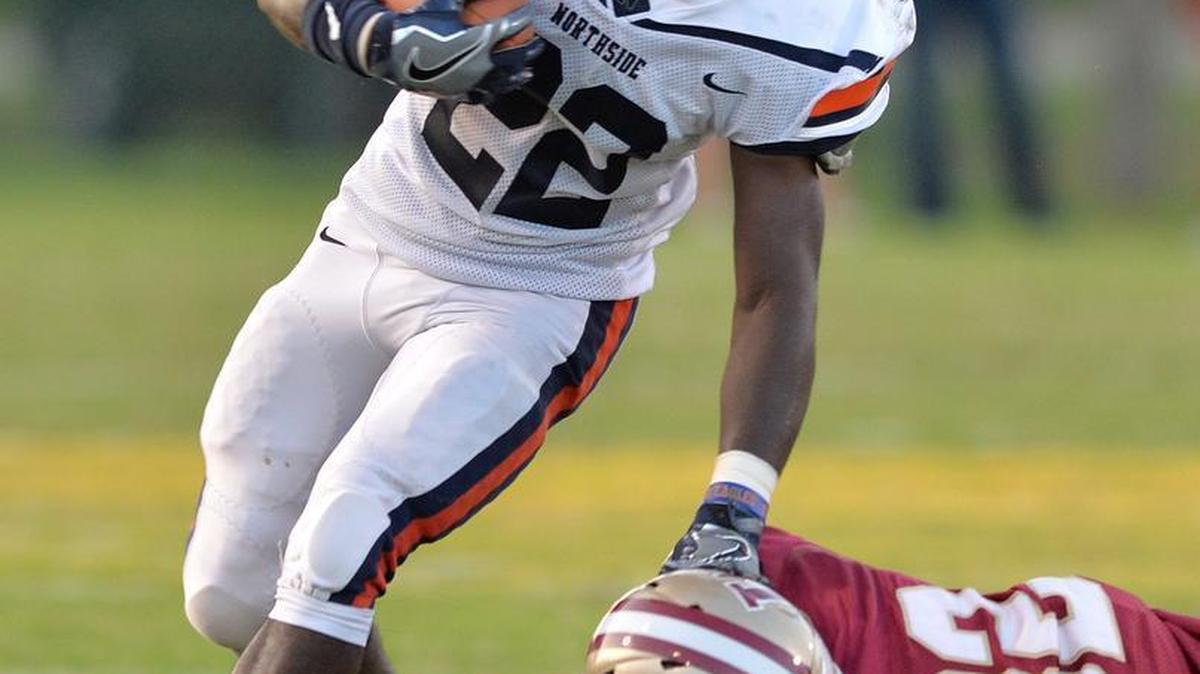 Northside's Trayvon Willis slips away from Westside's Nate Brookins in action Friday night.