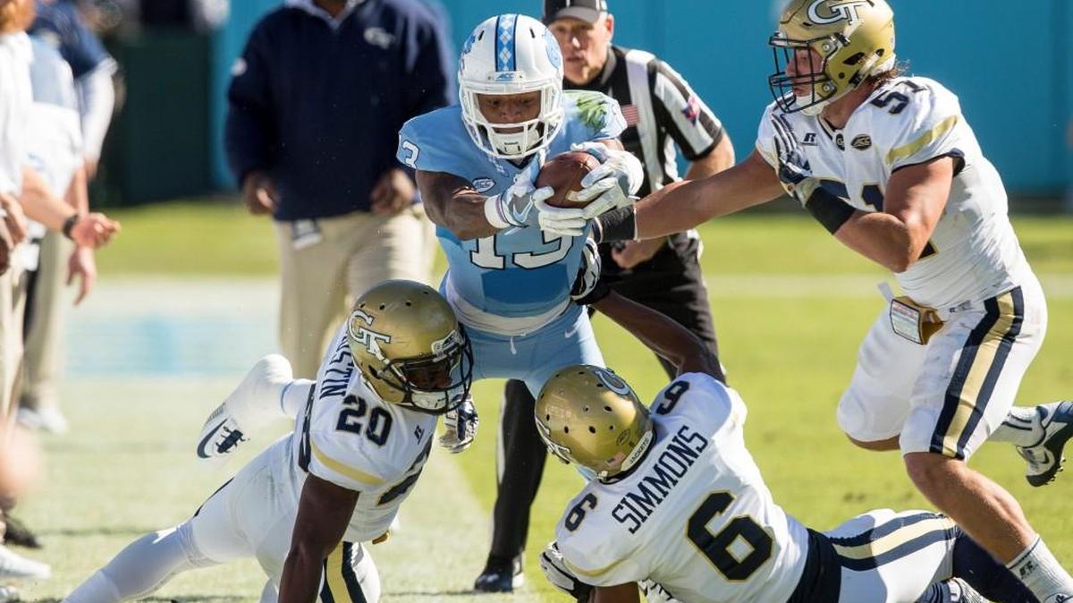 North Carolina's Bug Howard (13) attempts to stretch for a first down as Georgia Tech's Lawrence Austin (20), Lamont Simmons (6) and Brant Mitchell during Saturday’s game.