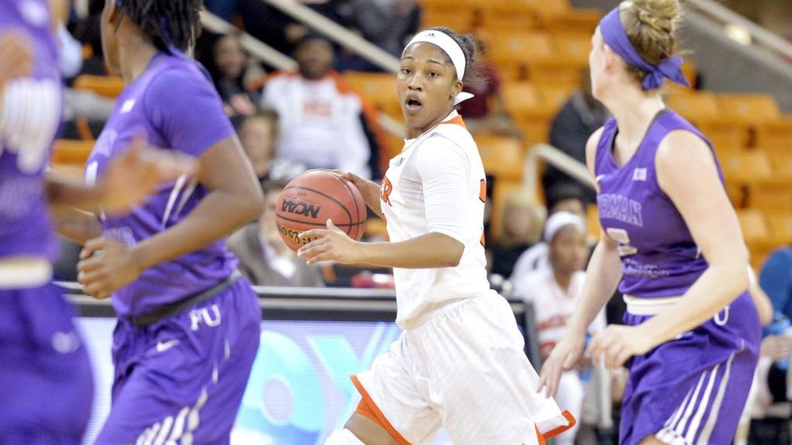 Mercer guard Sydni Means (1) calls out a play while driving the ball up court during their game against Furman Thursday night.