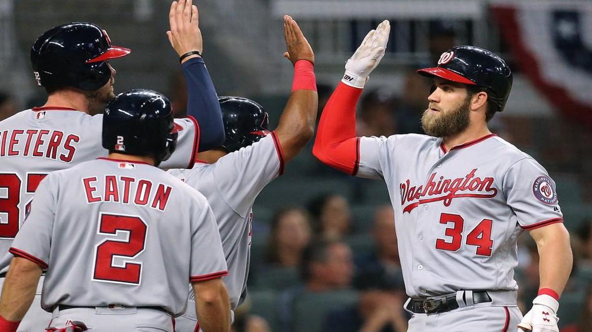 Washington’s Bryce Harper gets high-fives at home hitting a grand slam off Atlanta Braves pitcher Julio Jones during the second inning of a baseball game Wednesday, April 19, 2017, in Atlanta. Harper had a solo homer in the first inning.