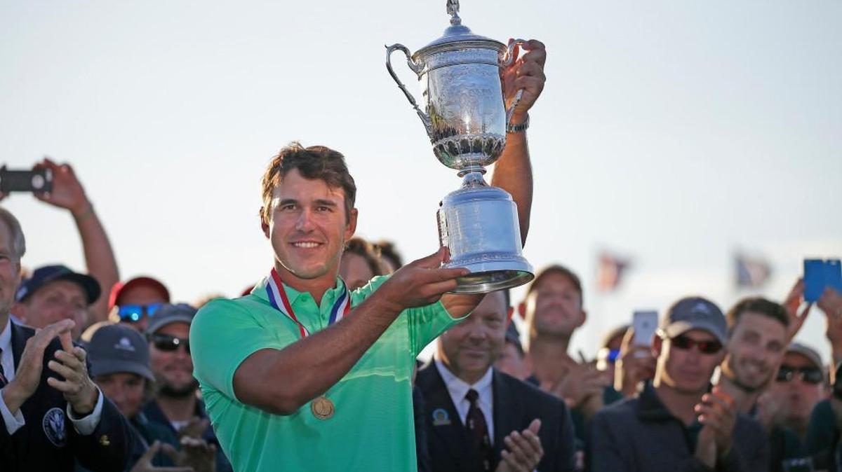 Brooks Koepka holds up the U.S. Open championship trophy following the final round of the 2017 U.S. Open Championship on Sunday, June 18, 2017 at Erin Hills in Hartford, Wis.