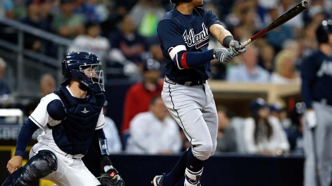 Atlanta’s Johan Camargo, right, hits a two-run double to center withe San Diego Padres catcher Luis Torrens, left, watching during the fourth inning of a baseball game in San Diego.