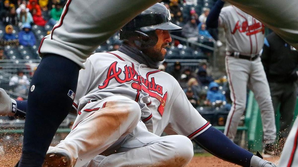 Atlanta Braves' Nick Markakis scores on a single by Brandon Phillips off Pittsburgh Pirates relief pitcher Wade LeBlanc during the eighth inning of a baseball game in Pittsburgh, Friday, April 7, 2017.