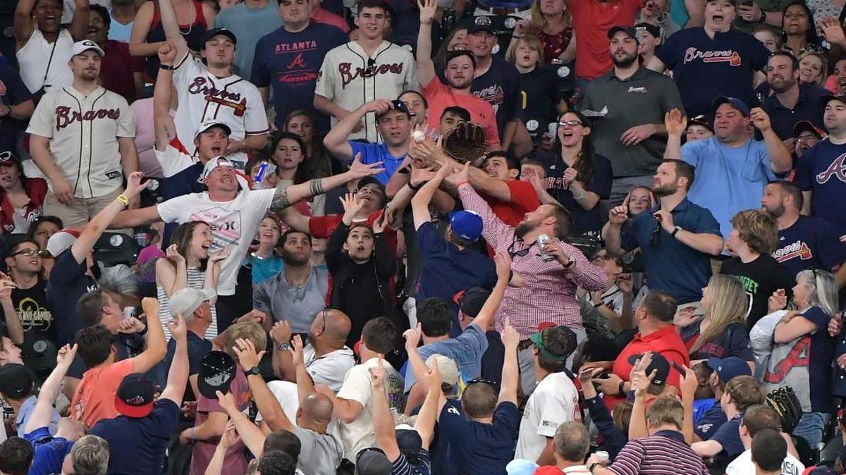 Fans try to catch a home run ball by the Atlanta Braves' Brandon Phillips in the sixth inning against the San Diego Padres at SunTrust Park in Atlanta on Saturday, April 15, 2017. The Braves won, 4-2.