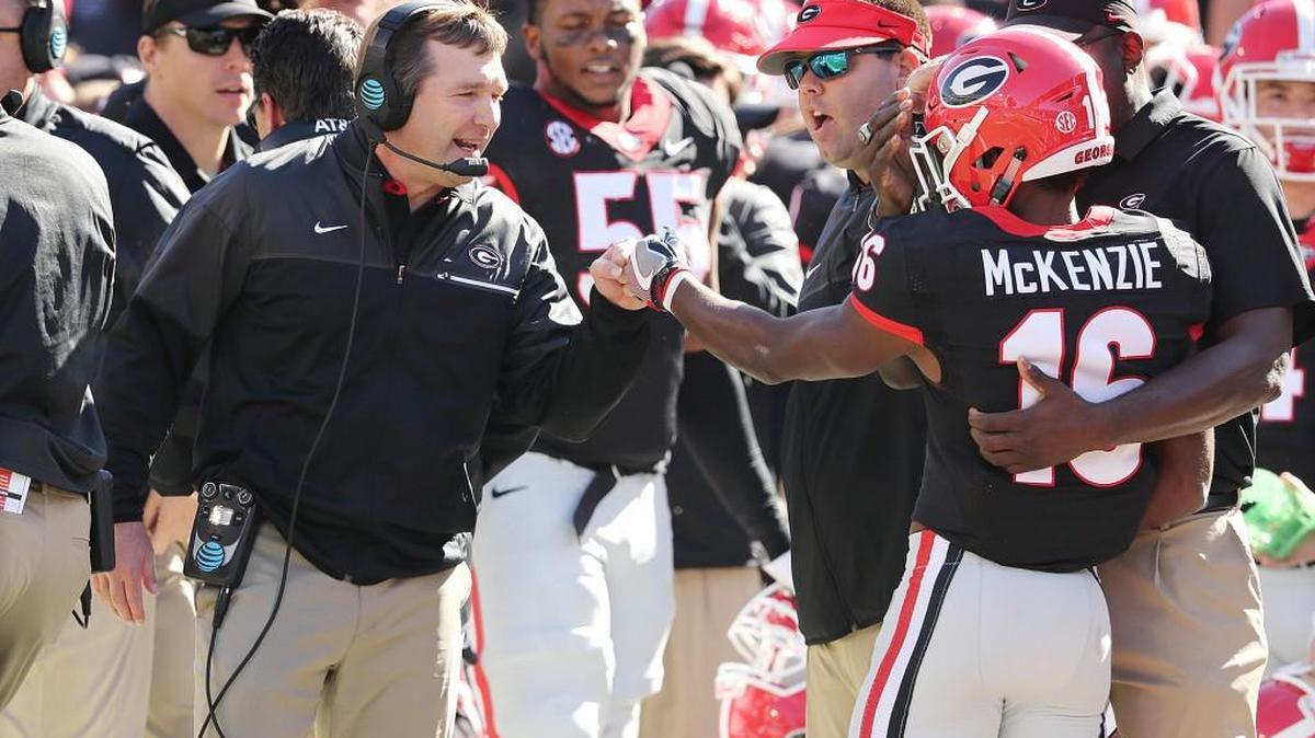 Georgia head coach Kirby Smart, left, is in his first season running the Bulldogs’ program.