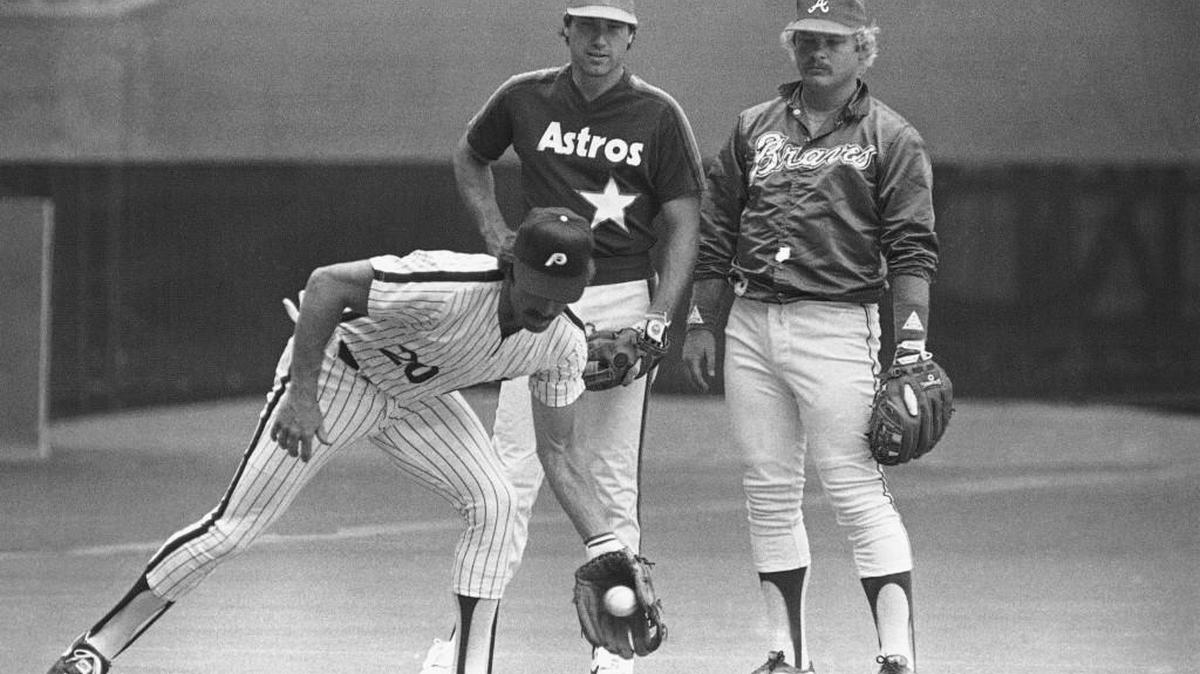 National League third baseman Mike Schmidt of the Philadelphia Phillies field a ball on Monday, July 12, 1982 in Montreal's Olympic Stadium as fellow NL All-Star third basemen Ray Knight, of the Houston Astros, and Bob Horner, right, if the Atlanta Braves, look on.