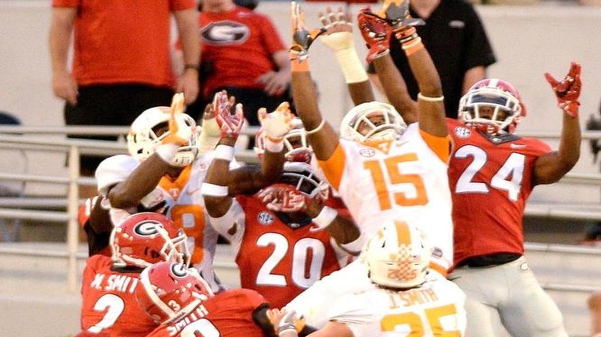 Tennessee receiver Jauan Jennings (15) leaps over Georgia defenders to haul in a Hail Mary catch to win the game Saturday.