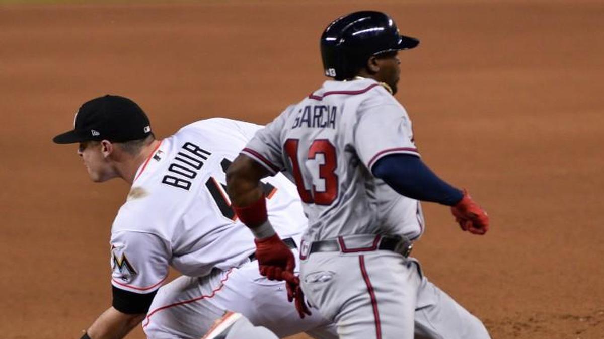 Miami first baseman Justin Bour puts out Atlanta’s Adonis Garcia during the sixth inning Friday.
