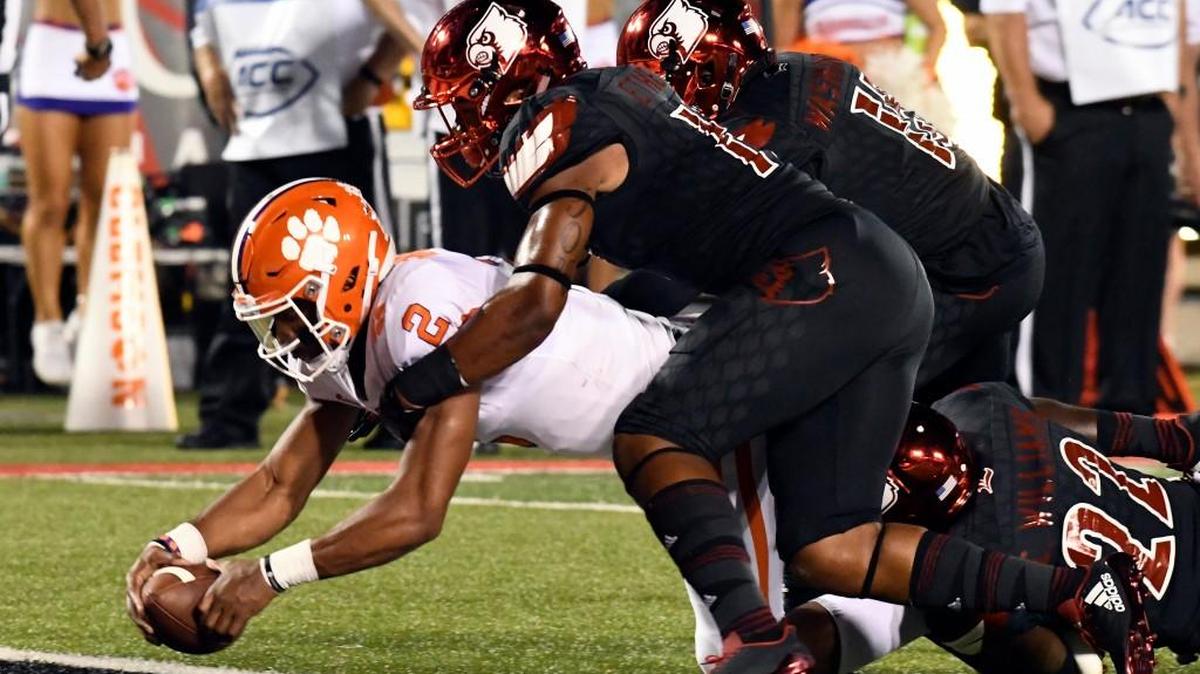 Clemson quarterback Kelly Bryant (2) is brought down by Louisville's Dorian Etheridge, front right, and Trumaine Washington (15) as he crosses the goal line during the first half of an NCAA college football game, Saturday, Sept. 16, 2017, in Louisville, Ky.