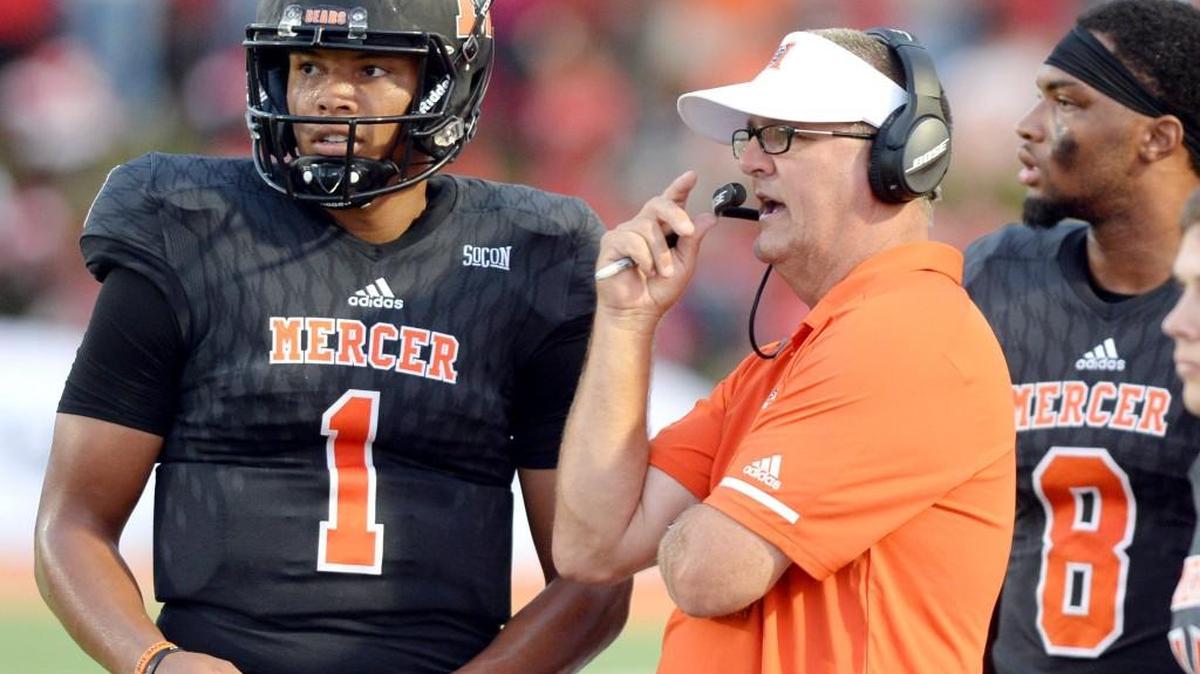 Mercer head coach Bobby Lamb speaks with quarterback Kaelan Riley (1) during the Bears' game against Jacksonville Thursday night.