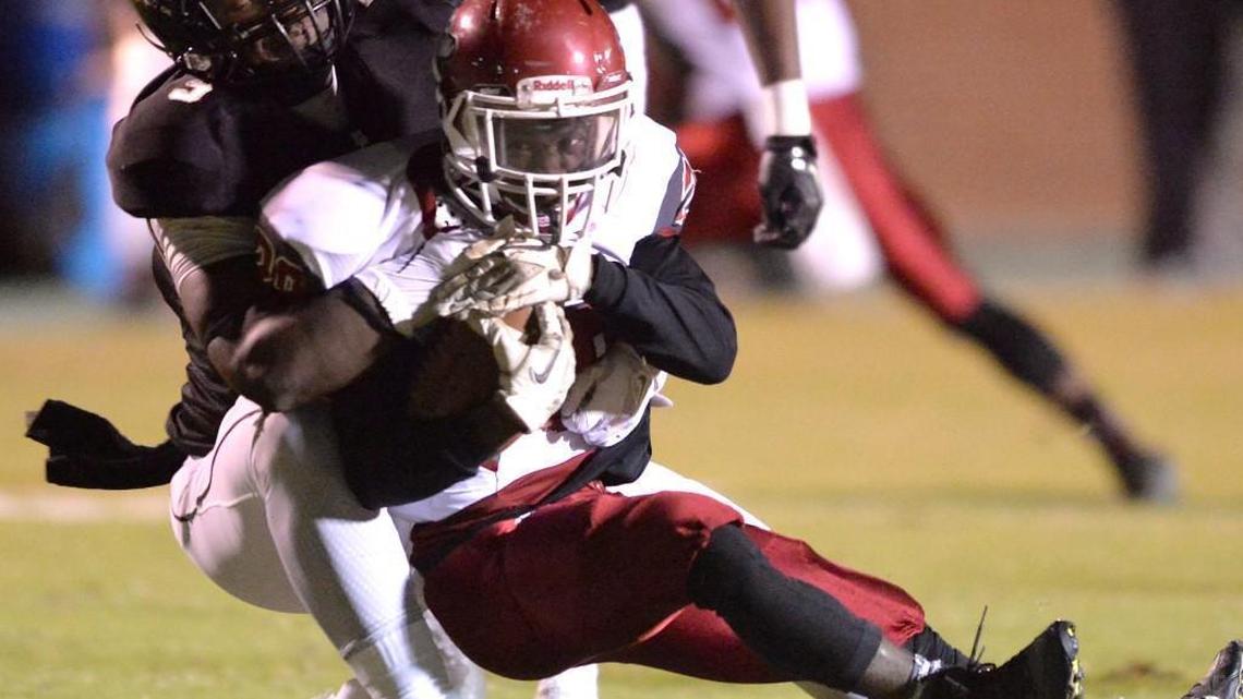 Mary Persons’ Malik Herring hauls down Howard’s Jeremiah Kelly in action Friday night at Dan Pitts Stadium.