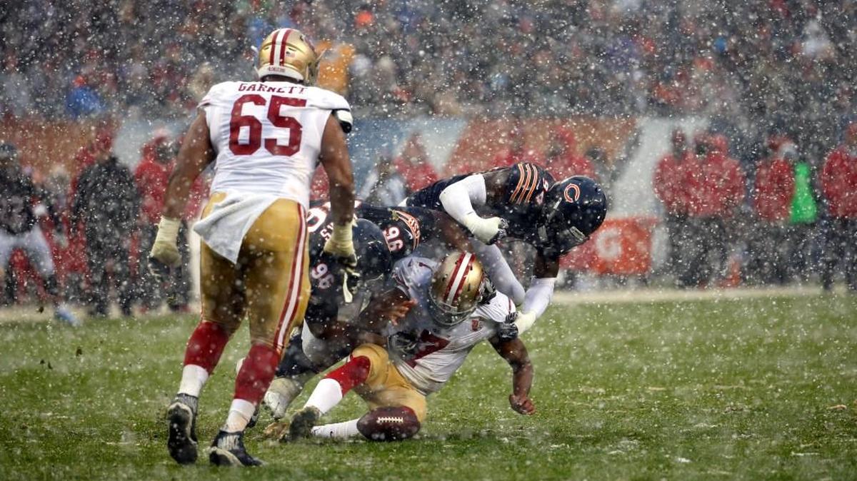 San Francisco 49ers quarterback Colin Kaepernick (7) fumbles as he is tackled by Chicago Bears defensive end Akiem Hicks (96) and outside linebacker Leonard Floyd (94) during the second half of an NFL football game, Sunday, Dec. 4, 2016, in Chicago.