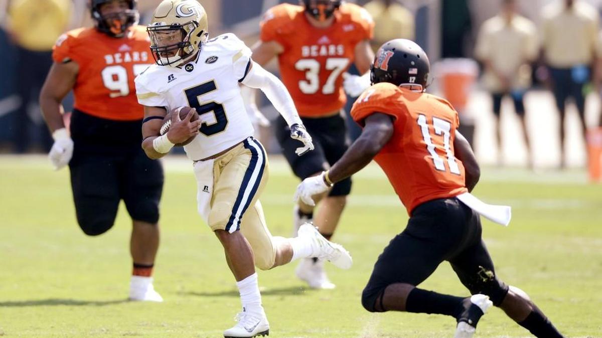 Georgia Tech quarterback Justin Thomas (5) runs by Mercer defenders for a first down during their game Saturday.