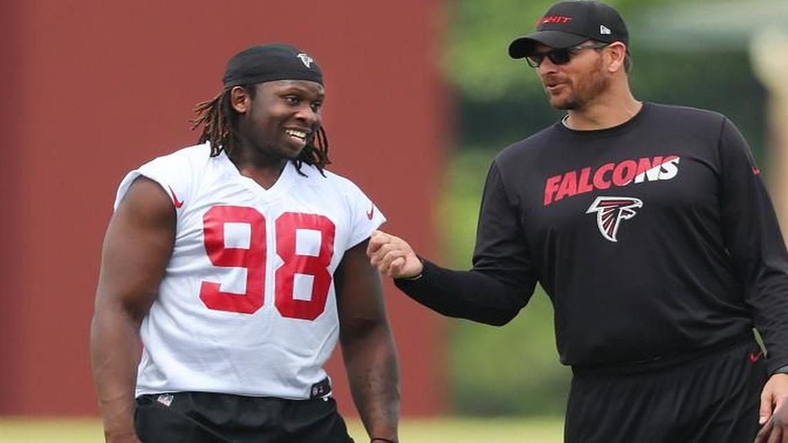 Atlanta Falcons first-round pick rookie defensive end/linebacker Takkarist McKinley talks with coaches during rookie mini-camp on Friday, May 12, 2017, in Flowery Branch.