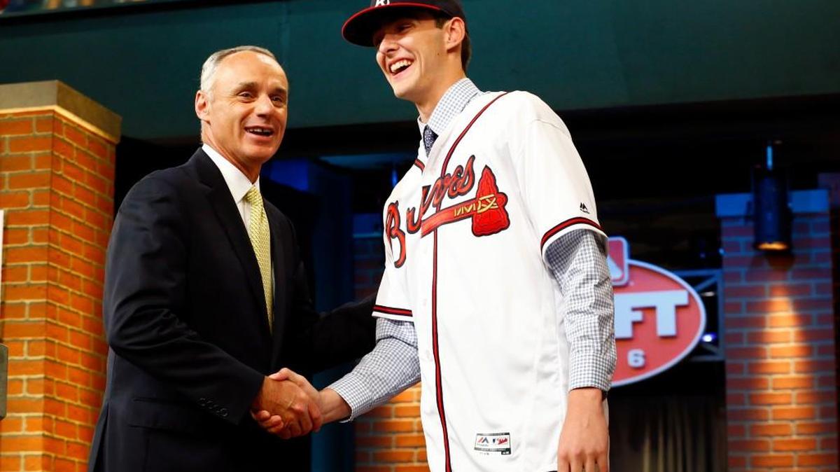 Commissioner Rob Manfred, left, shakes hands with Ian Anderson, a pitcher from Shenendehowa High School in Clifton Park, N.Y., after Anderson was drafted No. 3 by the Atlanta Braves in the first round of the Major League Baseball draft, Thursday, June 9, 2016, in Secaucus, N.J.