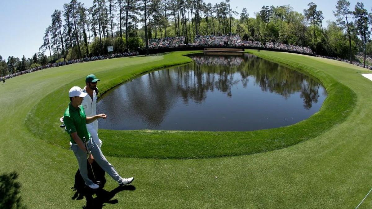 Jordan Spieth walks to the 15th green with his caddie during a practice round for the Masters on Tuesday.