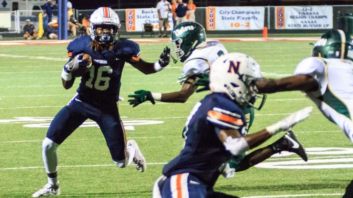 Northside’s Raymario Allen (16) gains yardage around end in the first half of their game Friday night against Ware County