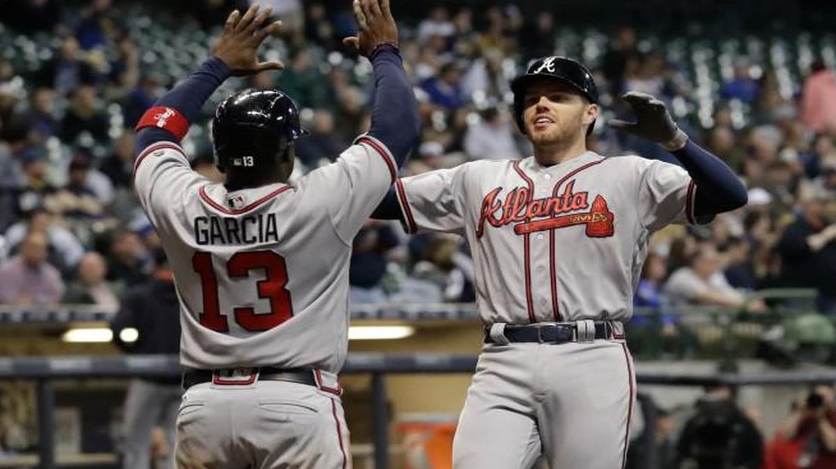 Atlanta Braves' Freddie Freeman is congratulated by Adonis Garcia (13) after hitting a two-run home run during the ninth inning of a baseball game against the Milwaukee Brewers Friday, April 28, 2017, in Milwaukee.