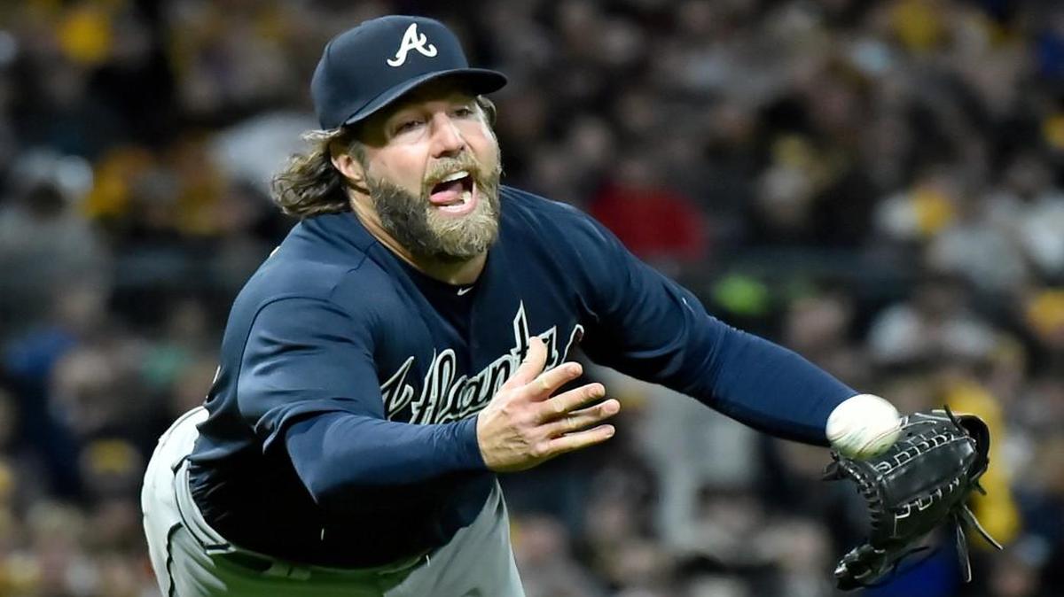 Atlanta Braves pitcher R.A. Dickey dives to throw out Pirates Francisco Cervelli in the fifth inning of a baseball game, Saturday, April 8, 2017, at PNC Park.
