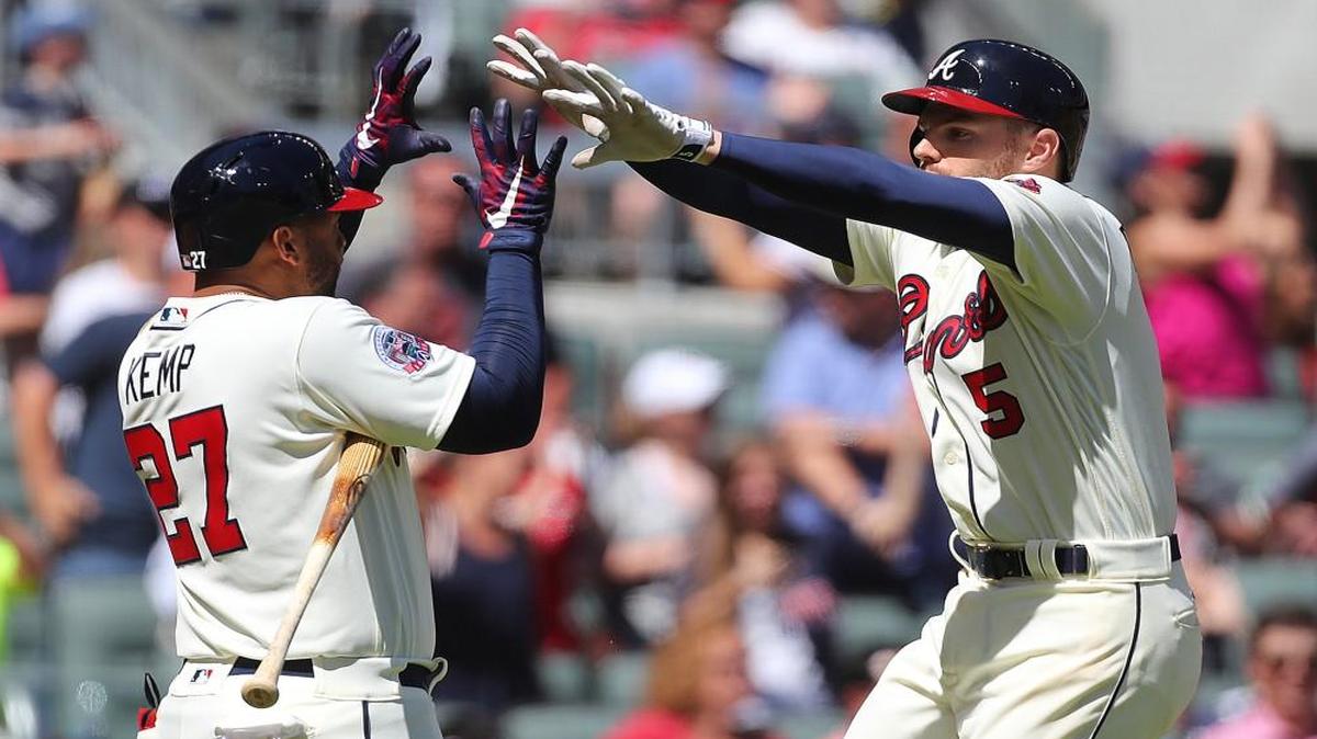 Atlanta’s Freddie Freeman gets five from Matt Kemp after hitting a solo home run to tie the game 4-4 with the St. Louis Cardinals during the eighth inning on Sunday, May 7, 2017, in Atlanta, Ga.