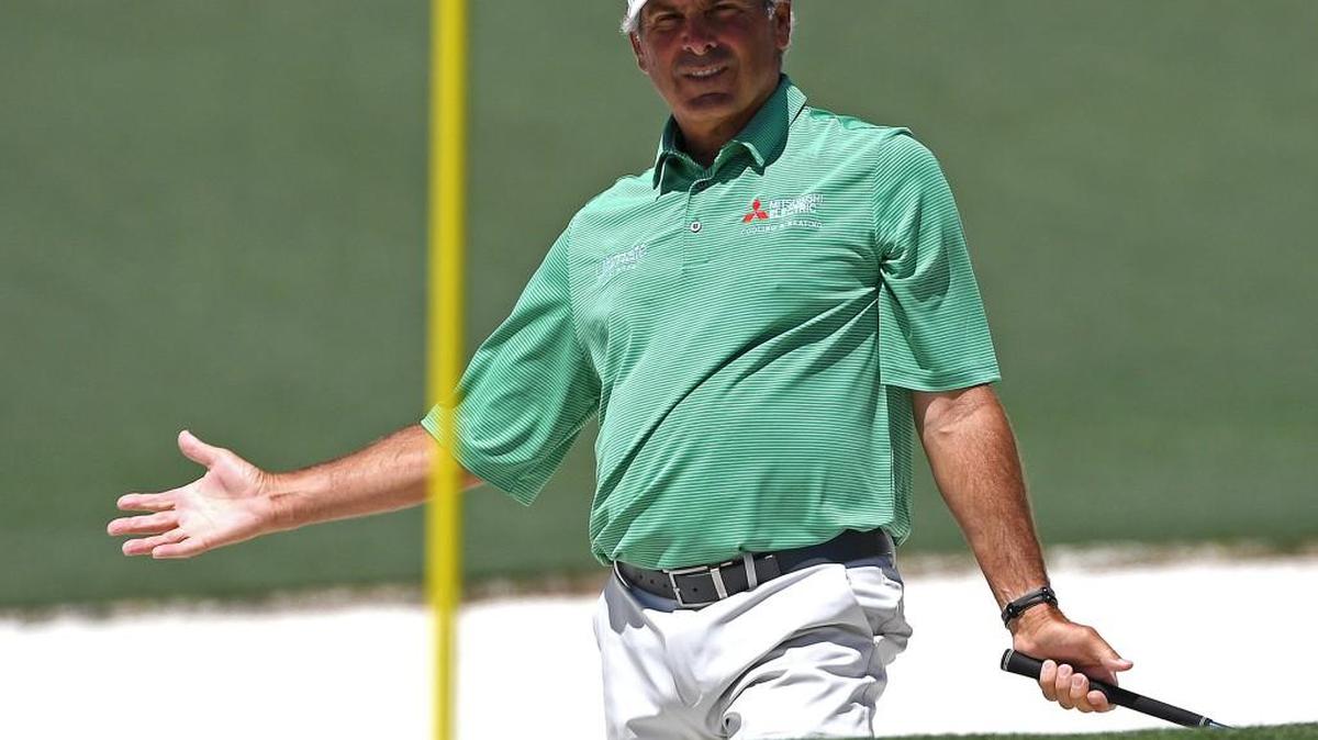 Fred Couples holds his arms out questioning why his ball did not go in the cup after hitting from a sand bunker along the second green during the final round of the Masters on Sunday.