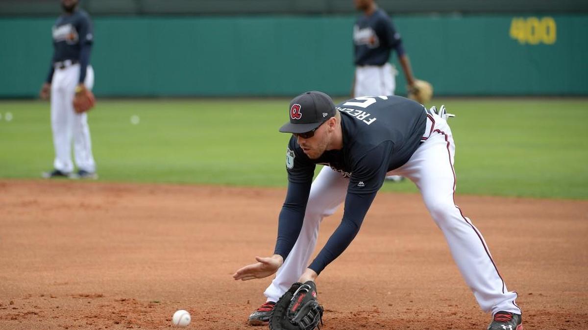 Atlanta Braves Freddie Freeman (5) fields a grounder at first base during the first full-squad spring training workout in Lake Buena Vista, Fla., Saturday, Feb. 18, 2017.