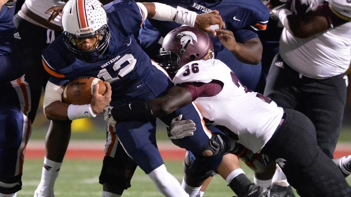 Northside quarterback Tobias Oliver dives through the Coffee County defensive line Friday night at McConnell Talbert Stadium.