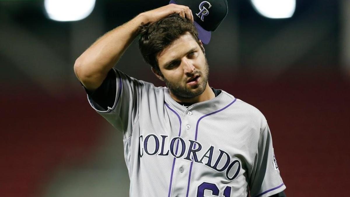 Colorado Rockies relief pitcher David Hale (61) takes off his cap as he is pulled from the game against the Cincinnati Reds during the eighth inning of a baseball game, Tuesday, April 19, 2016, in Cincinnati.