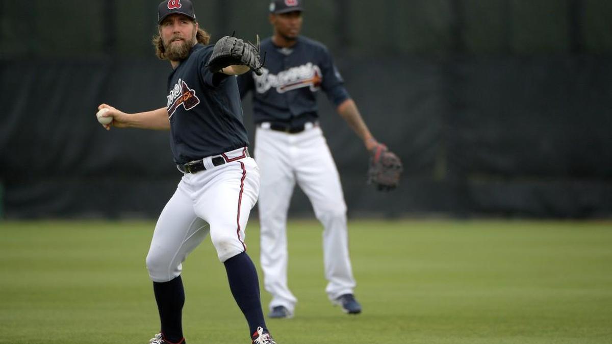 Atlanta Braves pitcher R.A. Dickey, left, warms up during the first full-squad spring training workout in Lake Buena Vista, Fla., Saturday, Feb. 18, 2017.