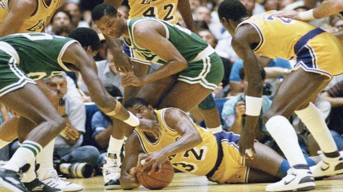 Earvin “Magic” Johnson scrambles for the ball on the floor of The Forum during the NBA Finals against the Boston Celtics in 1987.