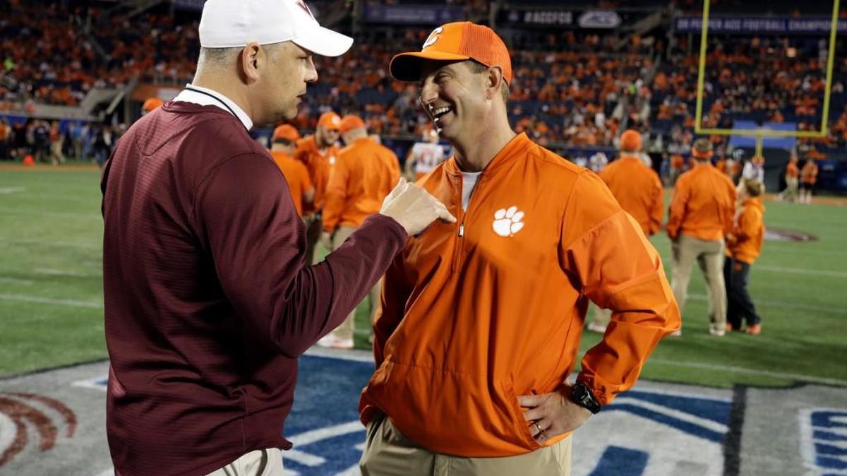FILE - In this Dec. 3, 2016, file photo, Virginia Tech head coach Justin Fuente, left, speaks to Clemson head coach Dabo Swinney, before the Atlantic Coast Conference championship NCAA college football game in Orlando, Fla. With a quarter of the college football season in the books, 24 undefeated teams remain, along with the possibility that each Power Five conference could have an undefeated champion. Thatâ€™s way off. For now, a couple of cross-divisional conference games matching ranked teams, No. 2 Clemson at No. 12 Virginia Tech and No. 5 Southern California at No. 16 Washington State, highlight the schedule and will be part whittling the field of unbeaten teams.