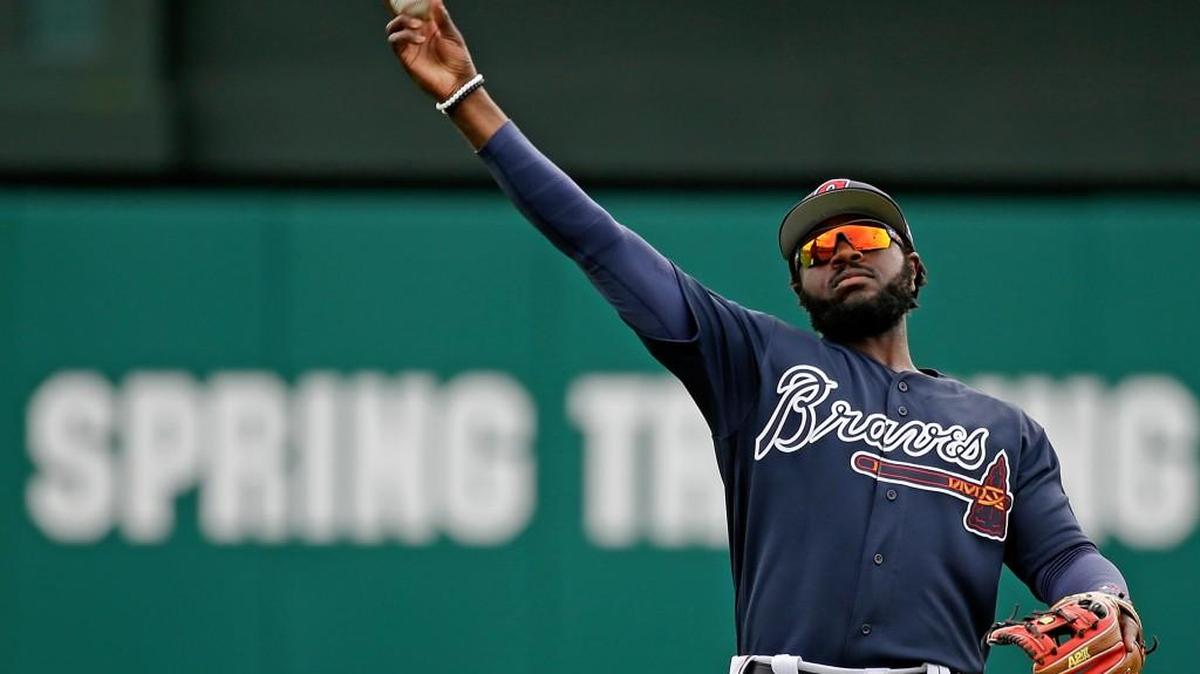 Atlanta Braves infielder Brandon Phillips throws during a spring training baseball workout, Tuesday, Feb. 21, 2017, in Kissimmee, Fla.